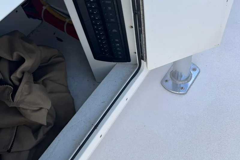 Slide: The Image of 2018 Jarrett Bay Center Console interior with control panel and storage area. - 10