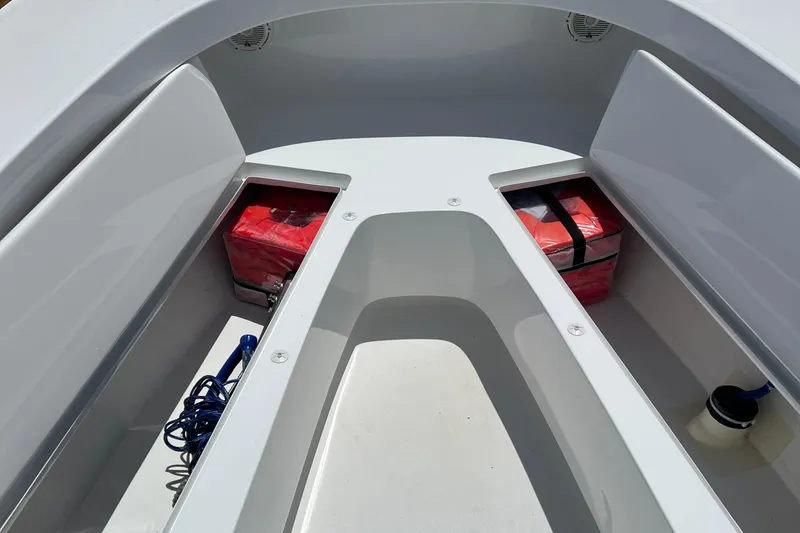 Slide: The Image of 2018 Jarrett Bay Center Console boat interior with storage compartments and safety equipment. - 11