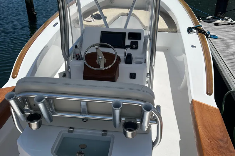 Slide: The Image of 2018 Jarrett Bay Center Console boat interior with steering wheel and controls. - 2