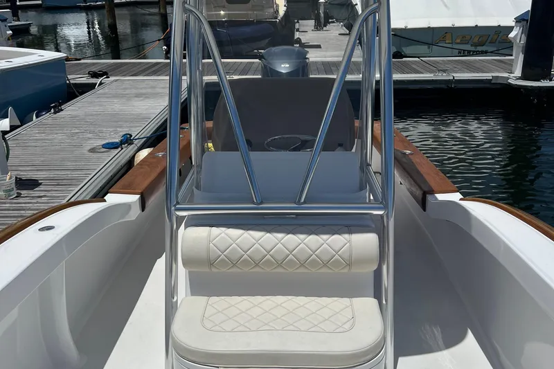 Slide: The Image of 2018 Jarrett Bay Center Console boat at dock, featuring sleek design and cushioned seating. - 3
