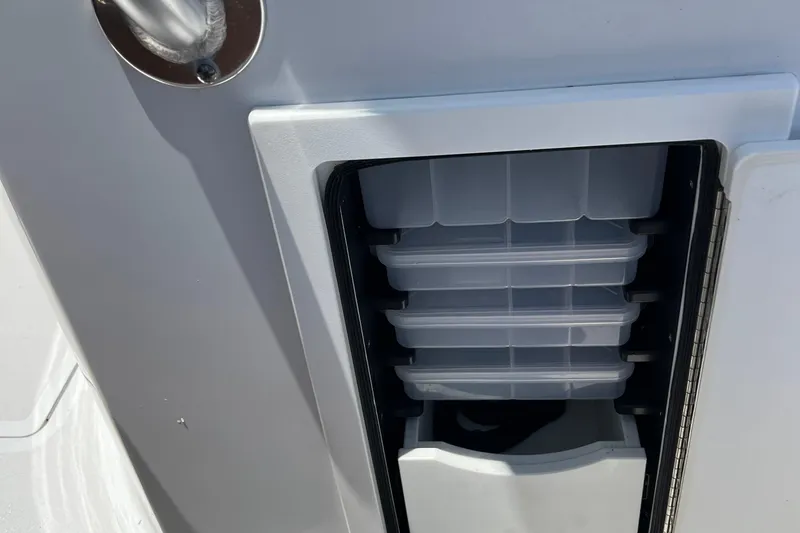 Slide: The Image of 2018 Jarrett Bay Center Console tackle storage compartment with multiple trays. - 6