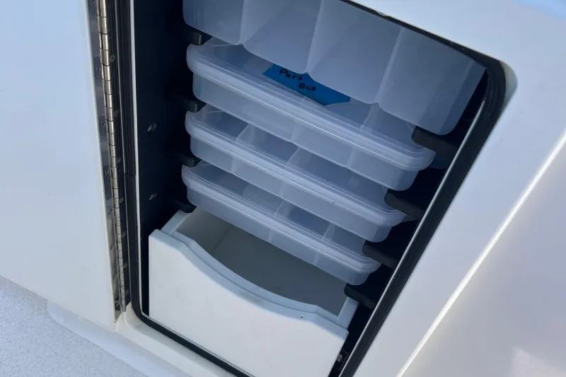 Slide: The Image of Storage compartment with tackle boxes on a 2018 Jarrett Bay Center Console boat. - 7
