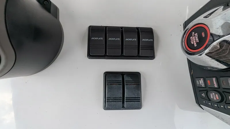 Slide: The Image of Control panel of a 2021 Vela 368 Center Console boat with switches and buttons. - 25