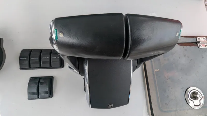 Slide: The Image of Throttle controls and switches on a 2021 Vela 368 Center Console boat. - 26