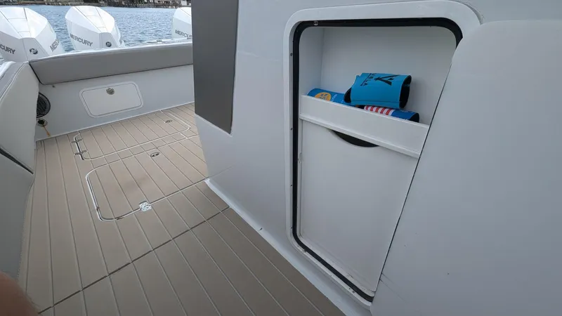 Slide: The Image of 2021 Vela 368 Center Console boat interior with storage compartment and deck view. - 31