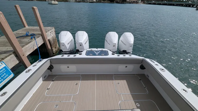 Slide: The Image of 2021 Vela 368 Center Console boat with four engines docked by the water. - 32