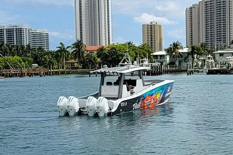 Slide: The Image of 2021 Vela 368 Center Console boat on water with city skyline background. - 35