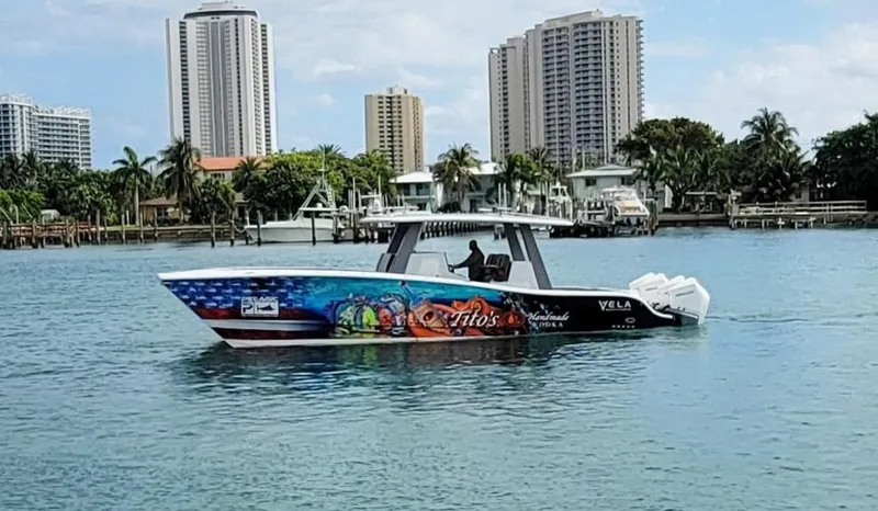 Slide: The Image of Vela 368 Center Console boat on water, city skyline in background, 2021 model. - 5