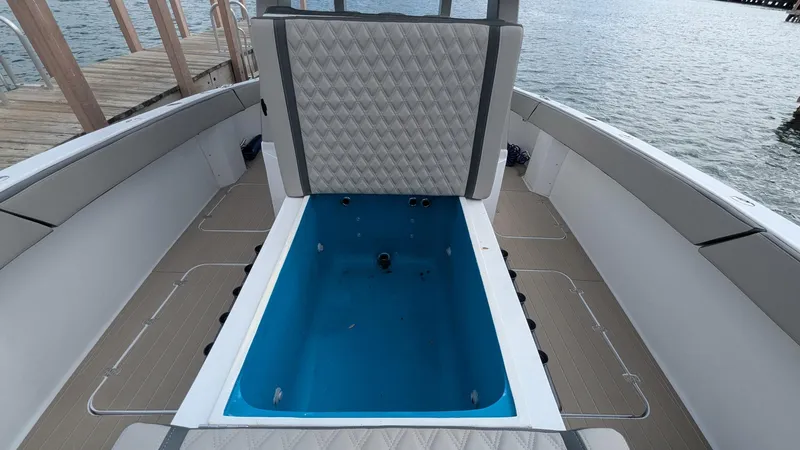 Slide: The Image of 2021 Vela 368 Center Console boat interior with seating and storage compartment. - 7