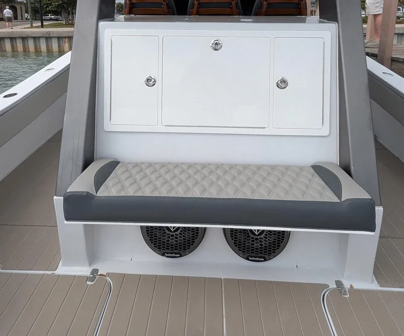 Slide: The Image of 2021 Vela 368 Center Console boat interior with cushioned seating and storage compartments. - 8