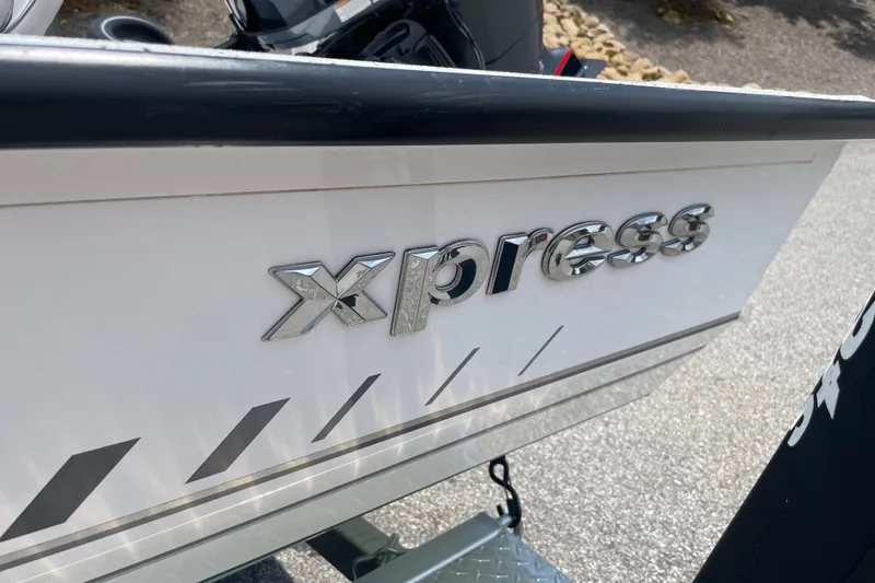 Slide: The Image of 2023 Express H22 boat with chrome logo and sleek design details. - 5