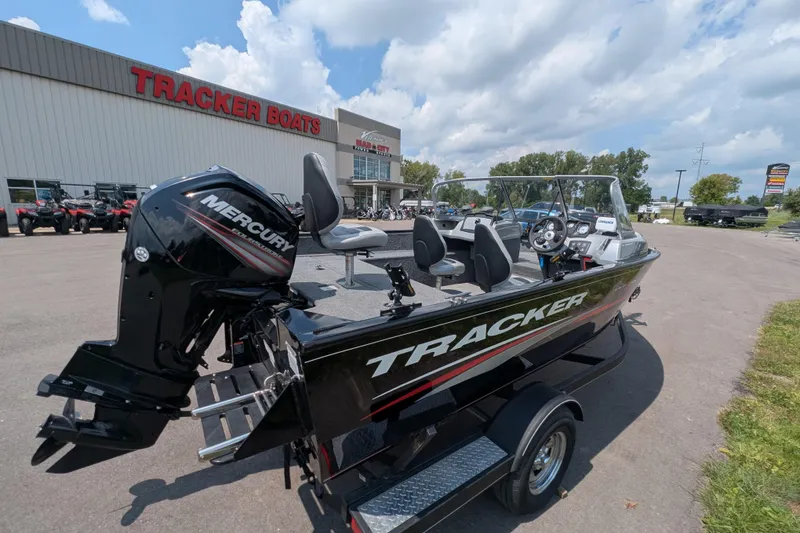 Slide: The Image of 2019 Tracker Pro Guide V-175 Combo boat with Mercury engine at dealership. - 2
