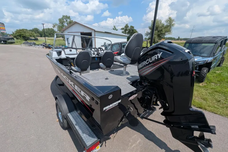Slide: The Image of 2019 Tracker Pro Guide V-175 Combo boat with Mercury engine, parked outdoors. - 3
