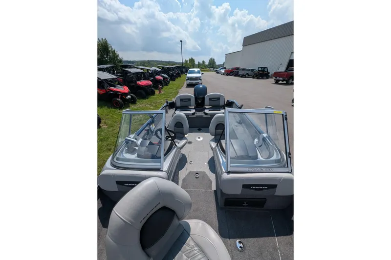 Slide: The Image of 2019 Tracker Pro Guide V-175 Combo boat with dual windshields, parked outdoors. - 6