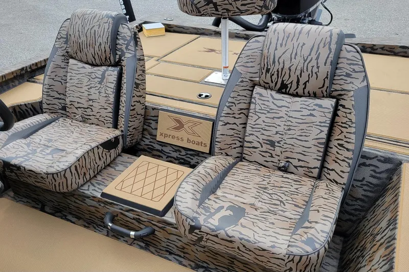Slide: The Image of 2026 Xpress H20 Bass boat interior with camo-patterned seats and Xpress branding. - 3