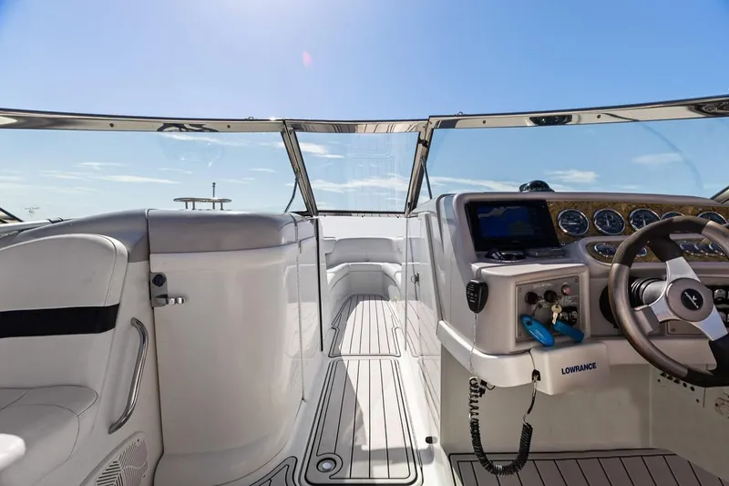 Slide: The Image of 2007 Formula 280 Bowrider cockpit with steering wheel, dashboard, and navigation equipment under clear skies. - 11
