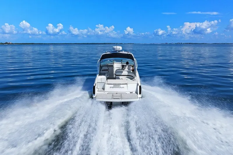 Slide: The Image of 2007 Formula 280 Bowrider cruising on open water under a clear blue sky. - 22