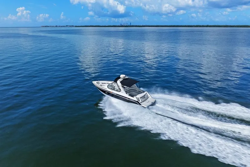 Slide: The Image of 2007 Formula 280 Bowrider cruising on open water under a clear blue sky. - 24