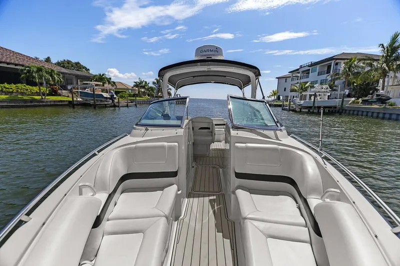 Slide: The Image of 2007 Formula 280 Bowrider boat on a sunny waterfront, featuring spacious seating and modern design. - 31