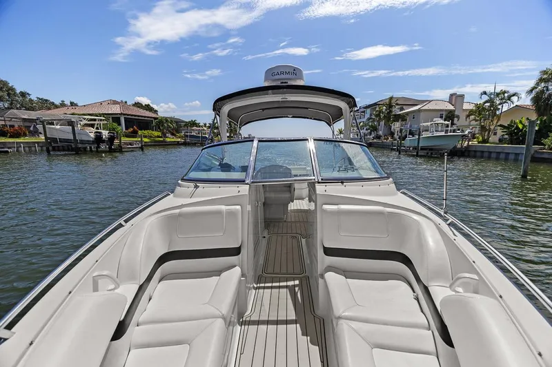 Slide: The Image of 2007 Formula 280 Bowrider boat on a sunny waterfront, featuring spacious seating and sleek design. - 32