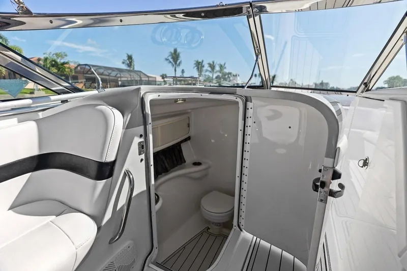 Slide: The Image of 2007 Formula 280 Bowrider boat interior with open bathroom door, showcasing sleek design. - 6