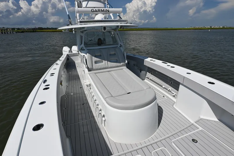 Slide: The Image of 2021 Freeman 37VH boat with Garmin equipment on calm water under a cloudy sky. - 12