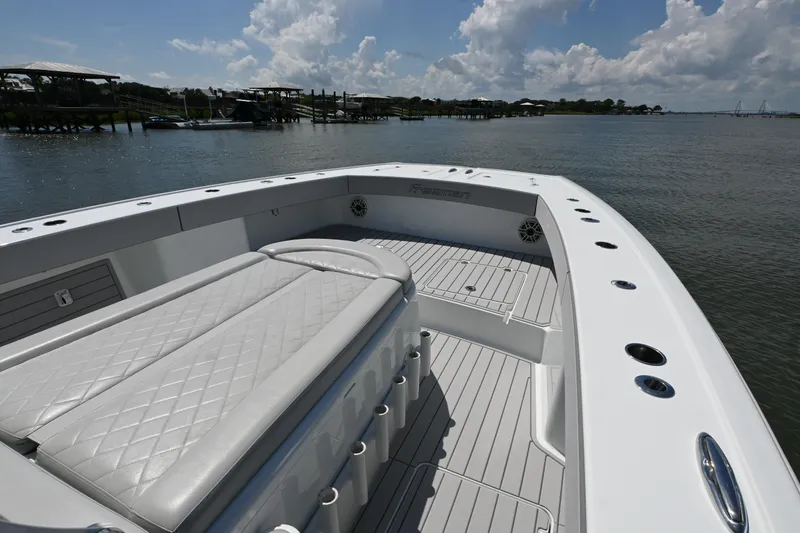 Slide: The Image of Luxury Freeman 37VH boat interior, 2021 model, featuring sleek seating and spacious deck on calm waters. - 13