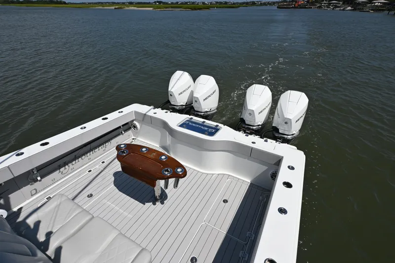 Slide: The Image of Freeman 37VH 2021 boat with four Mercury outboard engines on a calm waterway. - 24