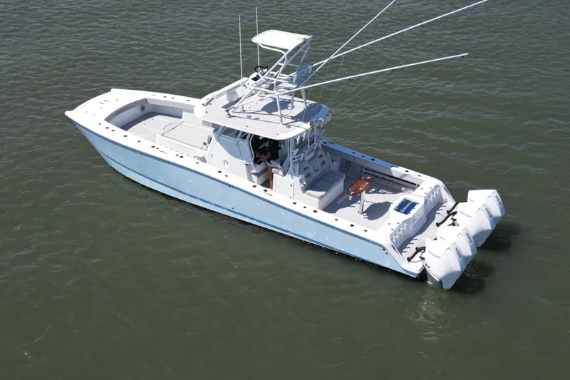 Slide: The Image of Aerial view of 2021 Freeman 37VH boat with triple outboard engines on water. - 3