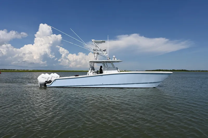 Slide: The Image of 2021 Freeman 37VH boat on calm water under a clear blue sky. - 4