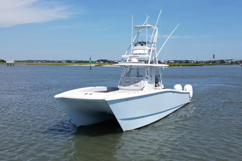 Slide: The Image of 2021 Freeman 37VH boat on calm water under clear blue sky. - 5