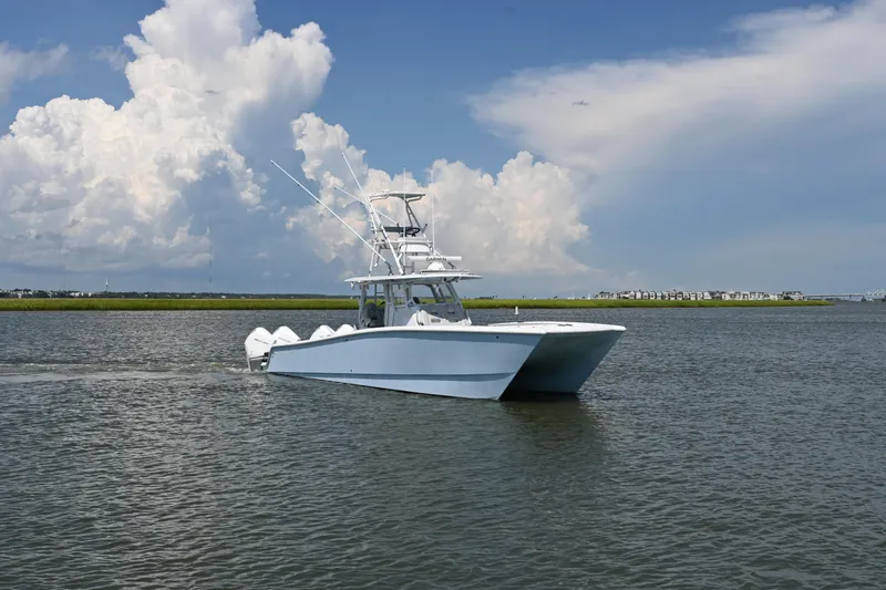Slide: The Image of Freeman 37VH 2021 boat cruising on a calm waterway under a cloudy sky. - 6