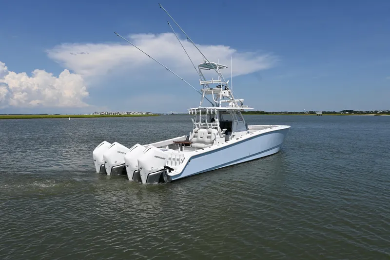 Slide: The Image of 2021 Freeman 37VH boat with multiple outboard engines on calm water. - 8