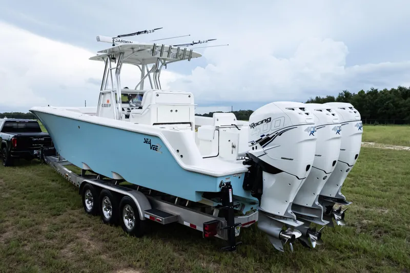 The Image of 2017 SeaVee 340Z boat on trailer, featuring sleek design and triple outboard engines. - 0