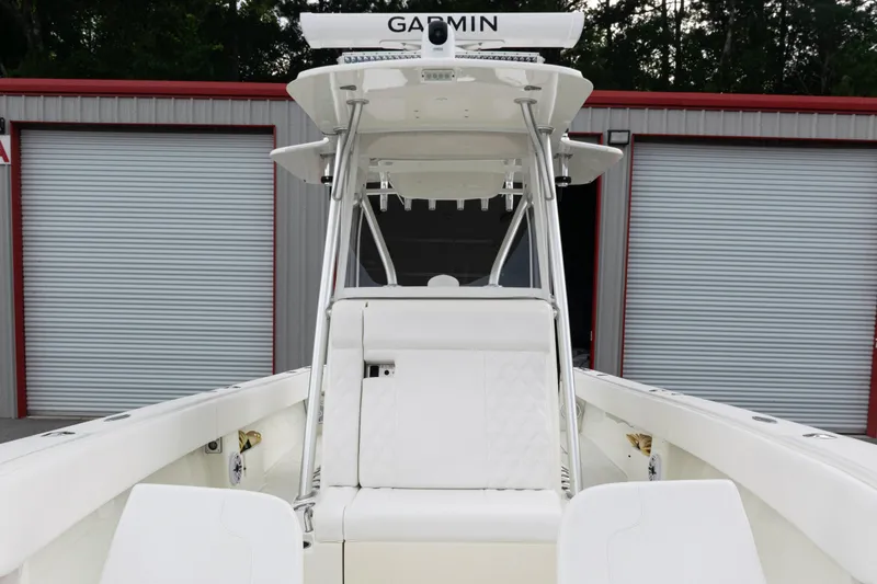Slide: The Image of 2017 SeaVee 340Z boat with Garmin equipment, docked near storage units. - 16