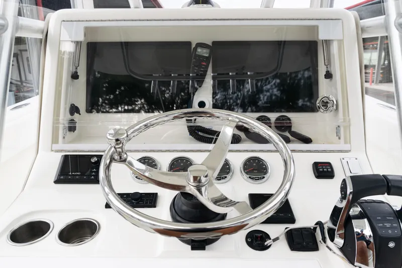 Slide: The Image of 2017 SeaVee 340Z boat dashboard with steering wheel and control panel. - 32