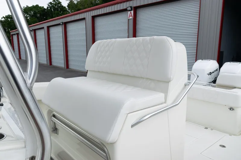 Slide: The Image of 2017 SeaVee 340Z boat with white cushioned seating and storage units in the background. - 34
