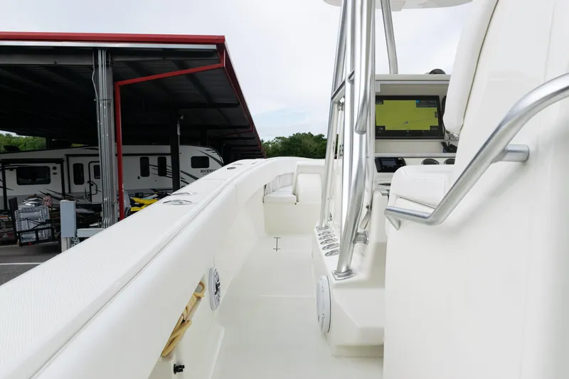 Slide: The Image of 2017 SeaVee 340Z boat interior with navigation display and seating, parked near RVs. - 37