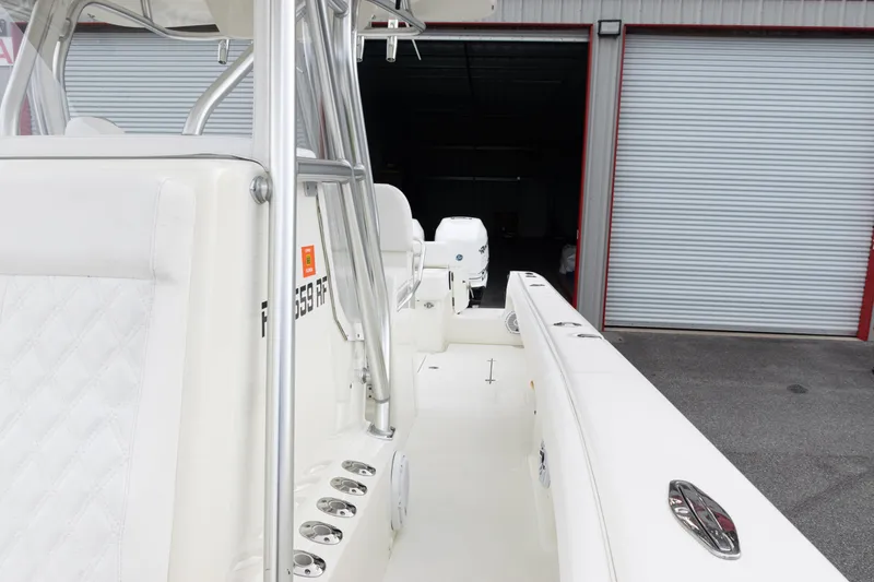 Slide: The Image of 2017 SeaVee 340Z boat interior with white seating and rod holders. - 38