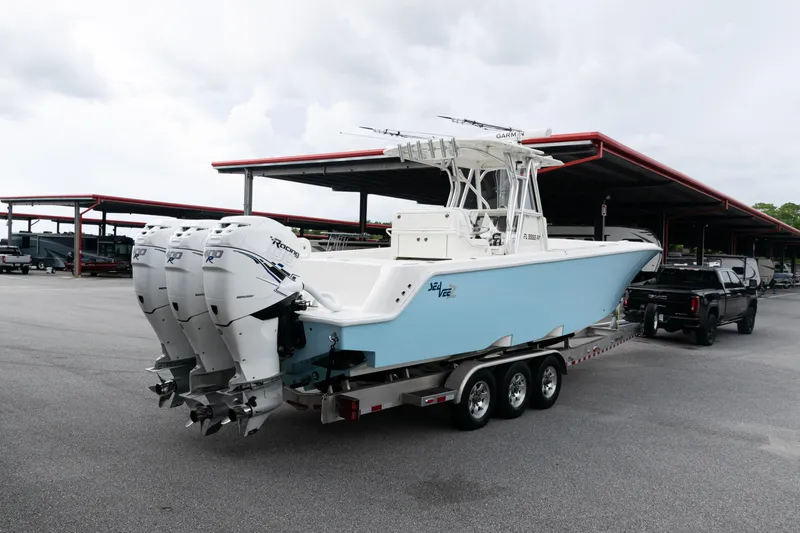 Slide: The Image of 2017 SeaVee 340Z boat with triple engines on a trailer in a parking area. - 44