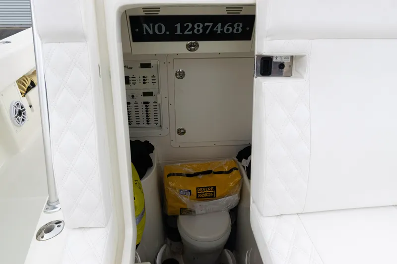 Slide: The Image of 2017 SeaVee 340Z boat interior with storage, control panel, and life-saving equipment. - 49