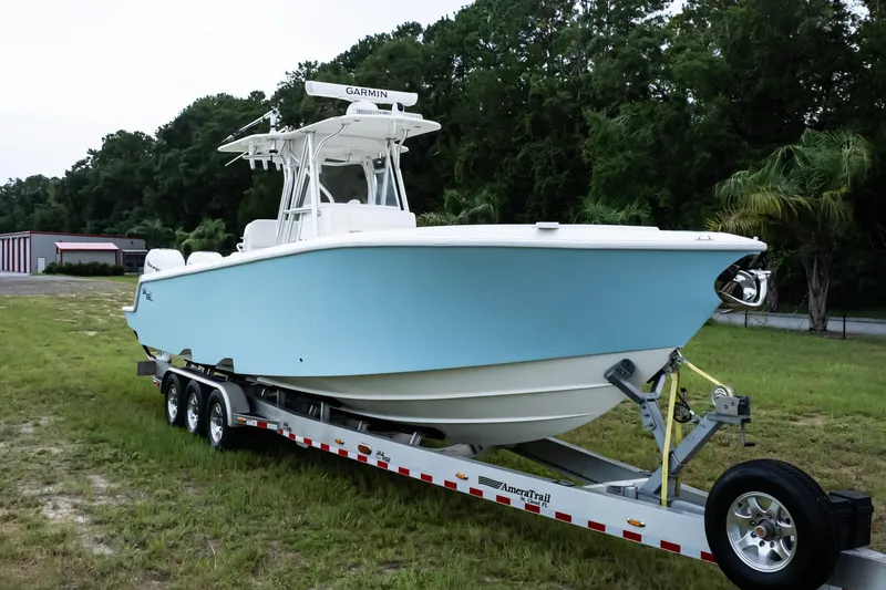 Slide: The Image of 2017 SeaVee 340Z boat on trailer, light blue hull, parked on grass. - 5