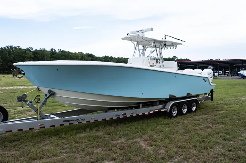 Slide: The Image of 2017 SeaVee 340Z boat on trailer, light blue hull, parked on grass. - 50
