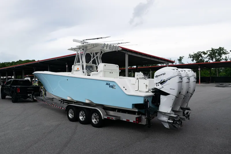 Slide: The Image of 2017 SeaVee 340Z boat on trailer with triple outboard engines in parking lot. - 51