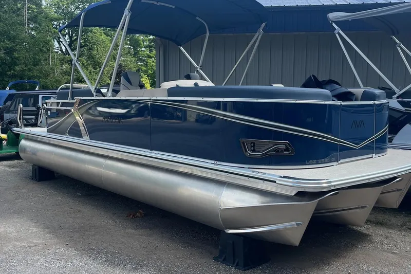 Slide: The Image of 2026 Avalon 23 LSZ Quad Lounger pontoon boat with blue exterior and canopy. - 7