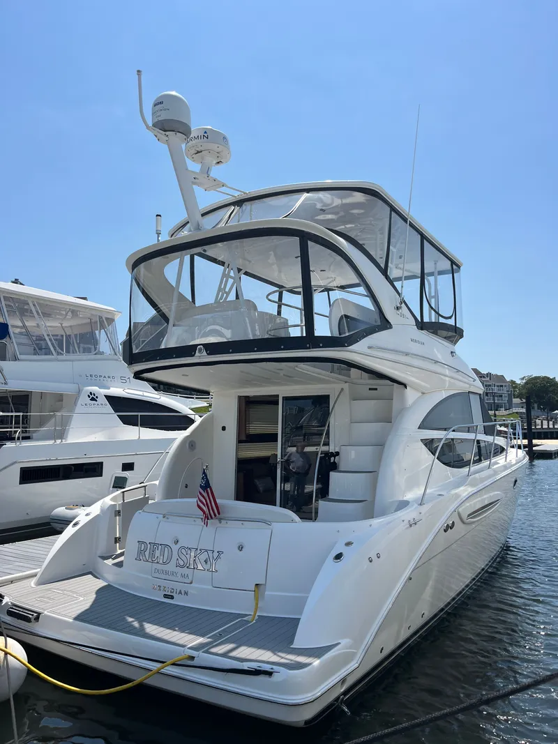 The Image of 2008 Meridian 391 Sedan yacht docked, featuring sleek design and spacious upper deck. - 0