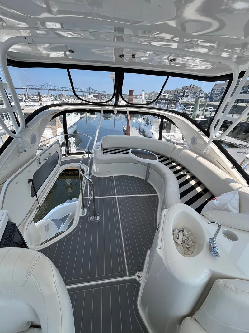 Slide: The Image of Luxurious 2008 Meridian 391 Sedan yacht interior with sleek seating and marina view. - 13