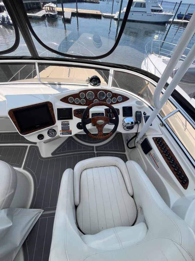 Slide: The Image of 2008 Meridian 391 Sedan helm with steering wheel, controls, and navigation equipment at marina. - 14