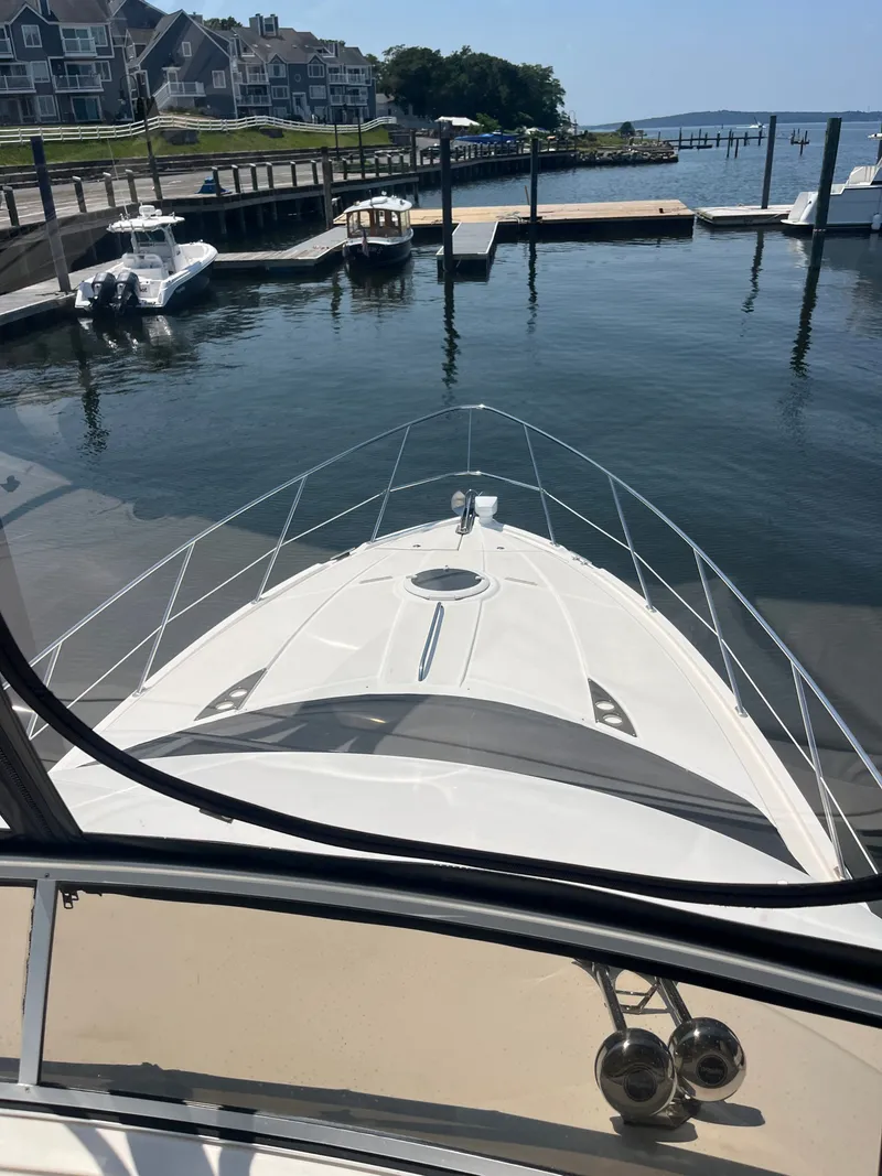 Slide: The Image of 2008 Meridian 391 Sedan yacht docked at a marina with waterfront homes. - 16