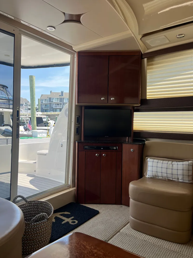 Slide: The Image of Interior of 2008 Meridian 391 Sedan yacht with TV, seating, and marina view. - 20
